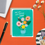 Get well greeting card with flowers and text 'Hope you feel better soon' on a colorful background