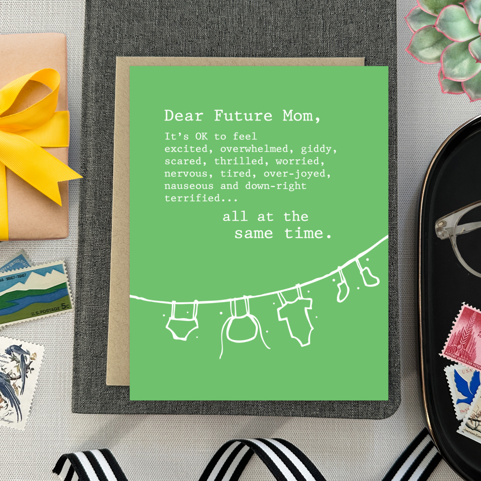 Baby greeting card with clothes hanging and 'dear future mom...' text