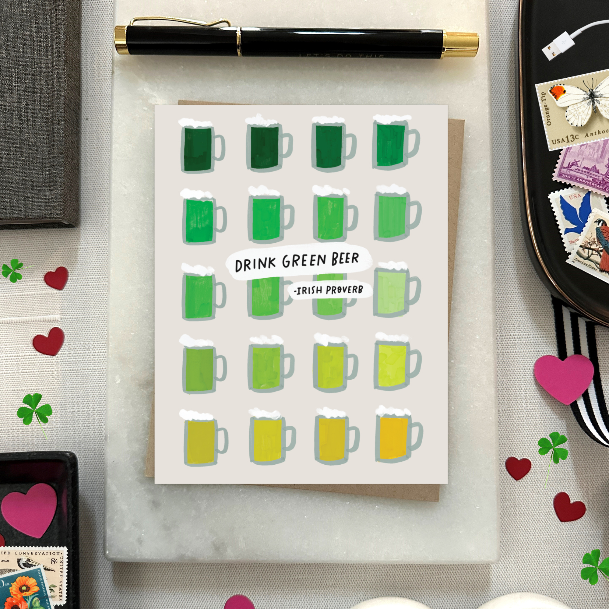 A st. patricks day greeting card with a grid of illustrated green beers in various shades and the text 'DRINK GREEN BEER - IRISH PROVERB'.