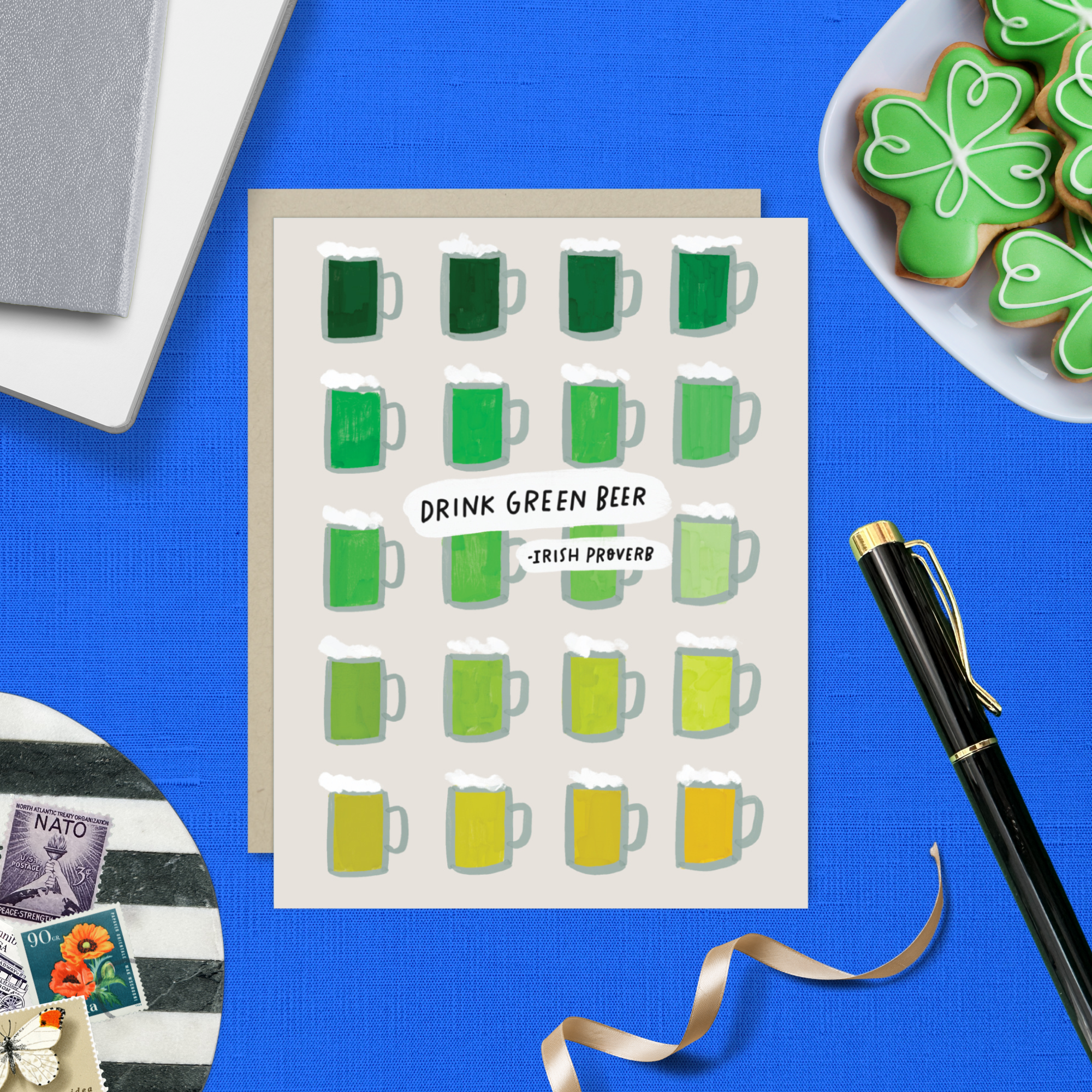 A st. patricks day greeting card with a grid of illustrated green beers in various shades and the text 'DRINK GREEN BEER - IRISH PROVERB'.