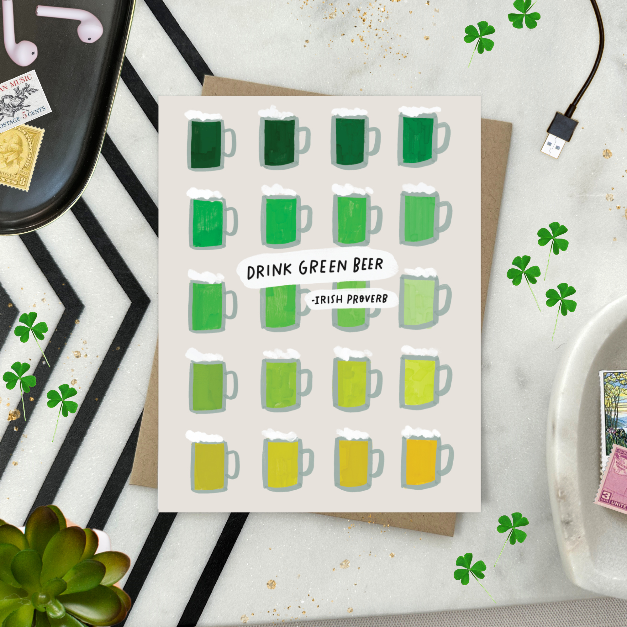 A st. patricks day greeting card with a grid of illustrated green beers in various shades and the text 'DRINK GREEN BEER - IRISH PROVERB'.