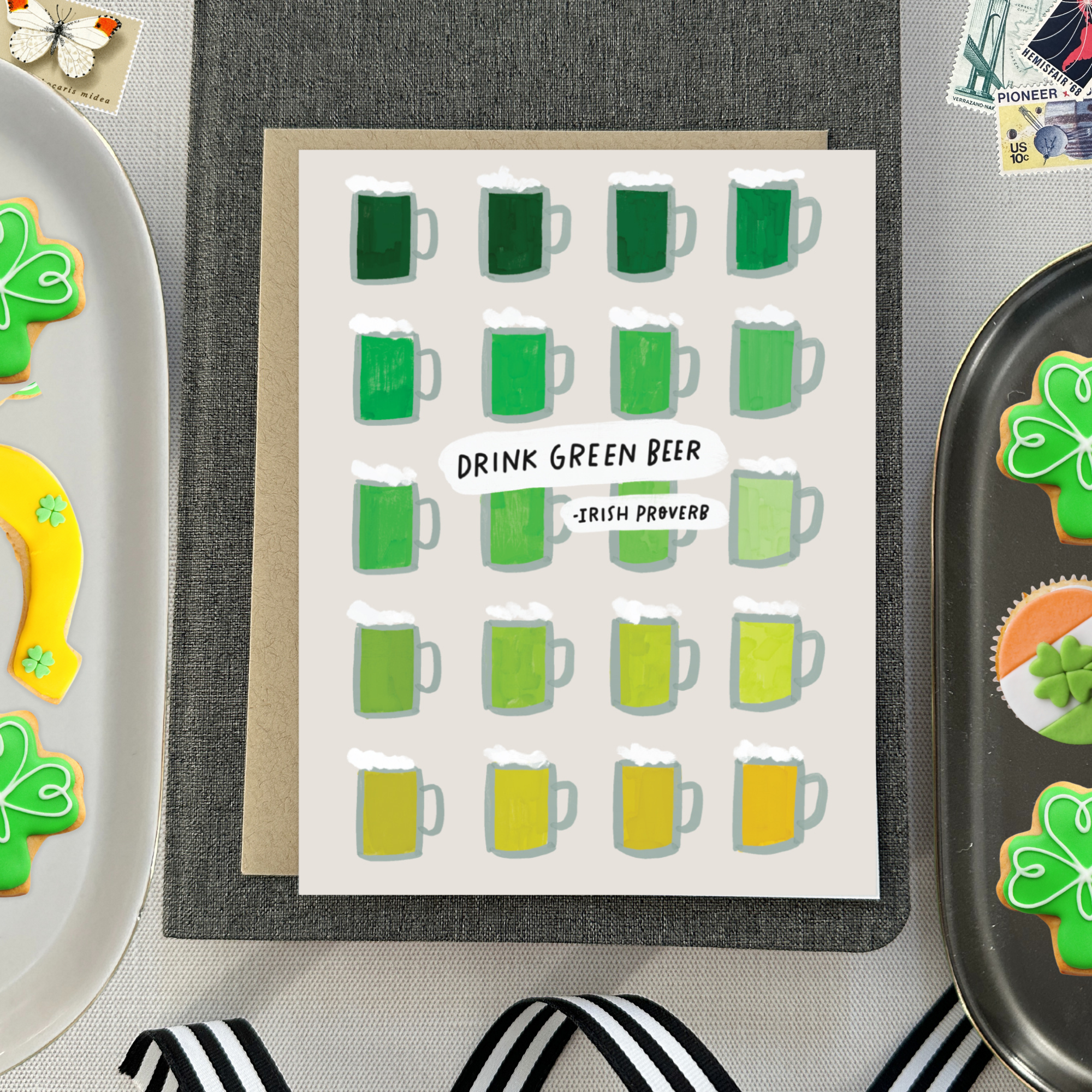 A st. patricks day greeting card with a grid of illustrated green beers in various shades and the text 'DRINK GREEN BEER - IRISH PROVERB'.