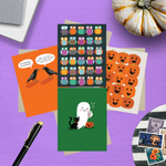 Collection of Halloween-themed greeting cards featuring an adorable ghost with black cat and coffee, one with 2 funny ravens saying "Nevermore," one with a jack-o-lantern pattern, and one with an owl pattern with stamps on a purple surface with a pumpkin and pen.