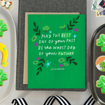 A St. Patricks day greeting card with floral patterns and a hand-lettered Irish proverb.