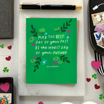 A St. Patricks day greeting card with floral patterns and a hand-lettered Irish proverb.