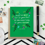A St. Patricks day greeting card with floral patterns and a hand-lettered Irish proverb.