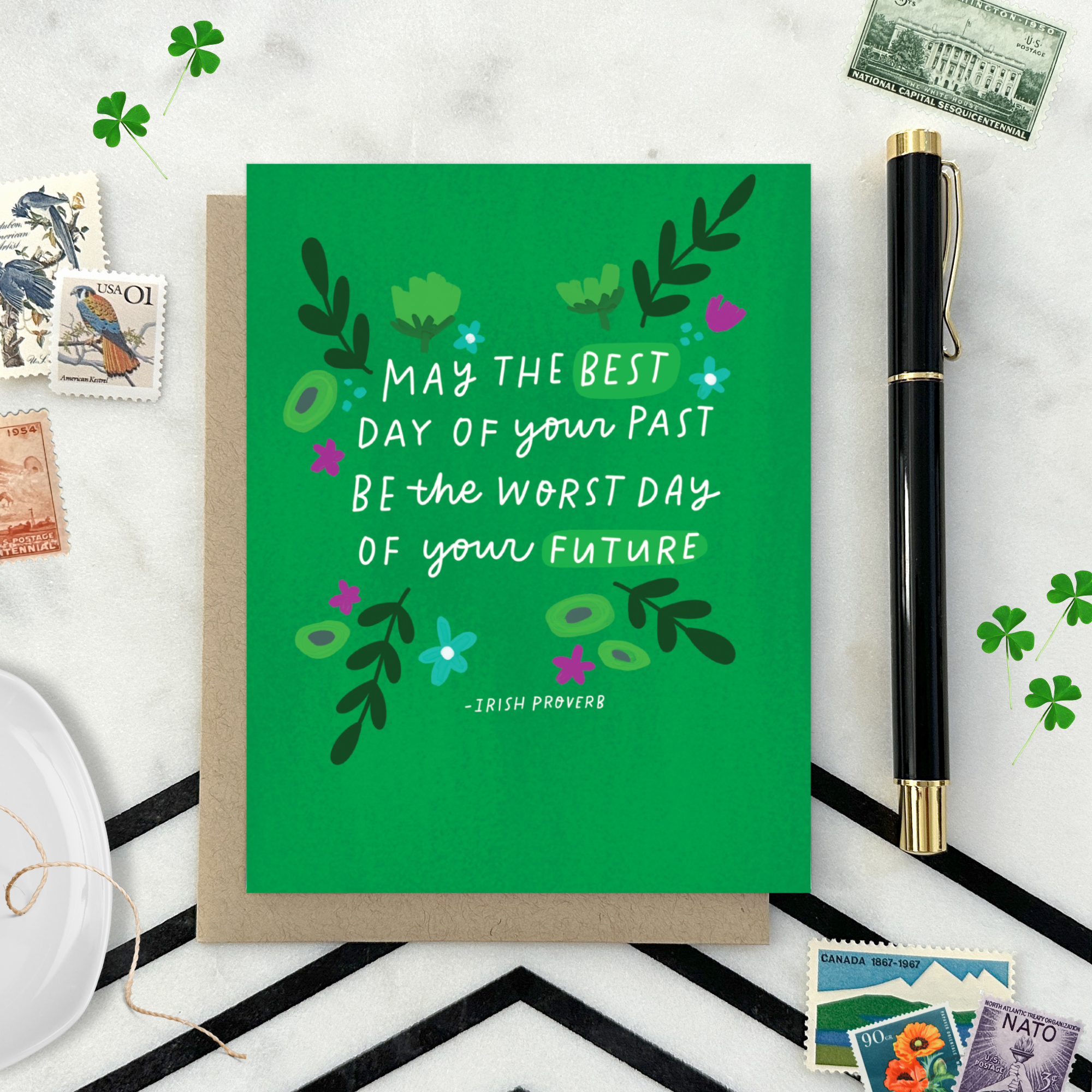 A St. Patricks day greeting card with floral patterns and a hand-lettered Irish proverb.