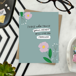 Sympathy greeting card with 2 flowers and 'those who touch your heart will live on forever' text