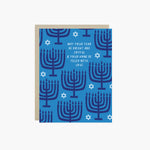 Hannukah greeting card with menorahs and stars of David scattered with 'may your year be bright and joyful & your home be filled with love' text