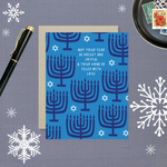 Hannukah greeting card with menorahs and stars of David scattered with 'may your year be bright and joyful & your home be filled with love' text