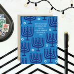Hannukah greeting card with menorahs and stars of David scattered with 'may your year be bright and joyful & your home be filled with love' text