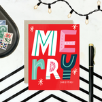 A festive Christmas greeting card with the word 'Merry' written in colorful, decorative lettering on a red background, with 'Christmas' written below.