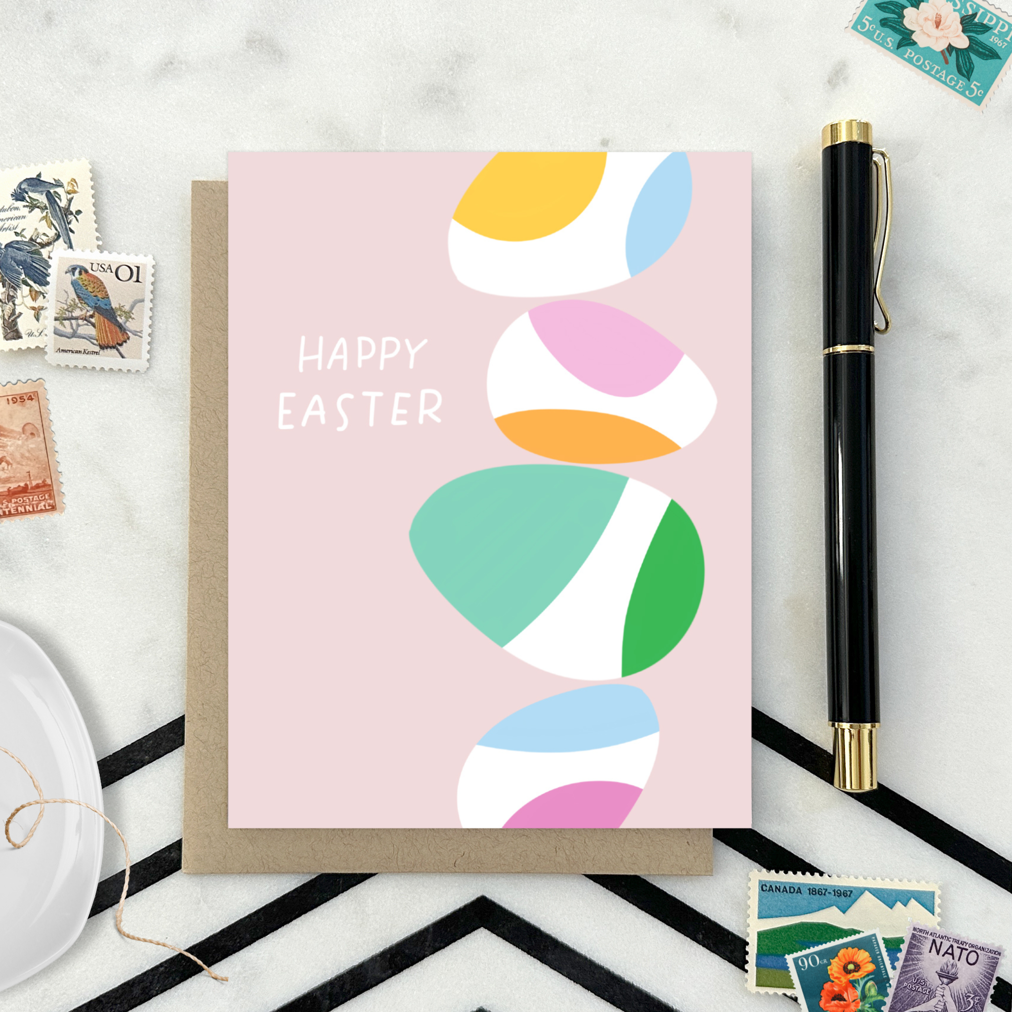 Easter greeting card with stack of eggs and 'happy easter' text