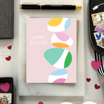 Easter greeting card with stack of eggs and 'happy easter' text