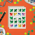 A St. Patrick's Day greeting card featuring a grid of colorful, painterly shamrocks with the message 'Happy St. patricks day