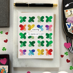 A St. Patrick's Day greeting card featuring a grid of colorful, painterly shamrocks with the message 'Happy St. patricks day