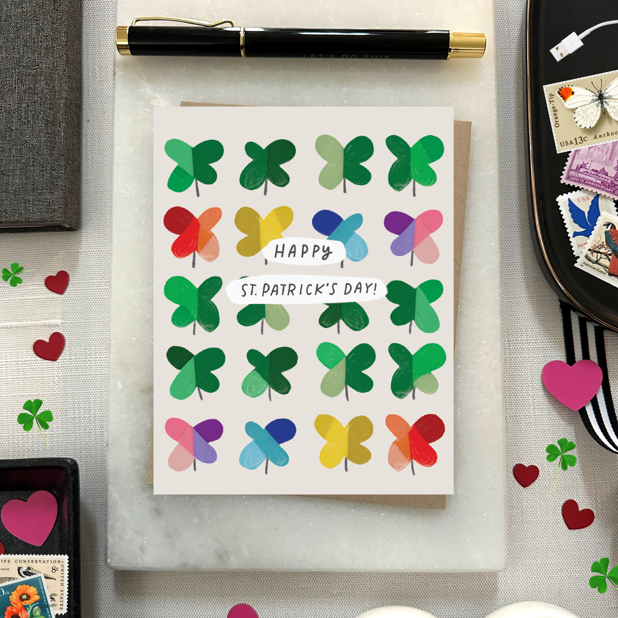 A St. Patrick's Day greeting card featuring a grid of colorful, painterly shamrocks with the message 'Happy St. patricks day