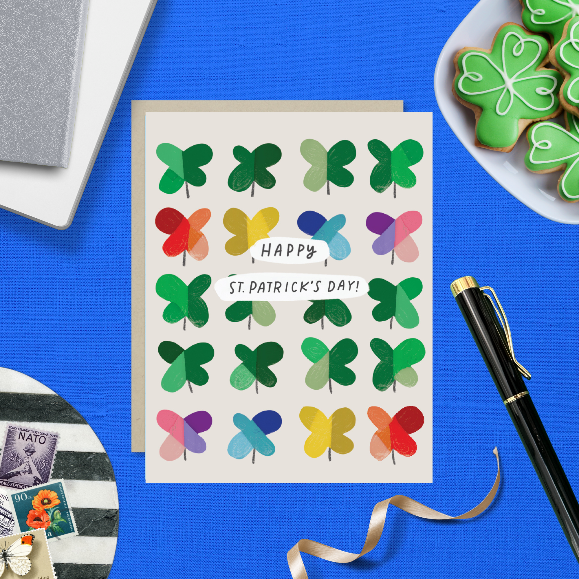 A St. Patrick's Day greeting card featuring a grid of colorful, painterly shamrocks with the message 'Happy St. patricks day