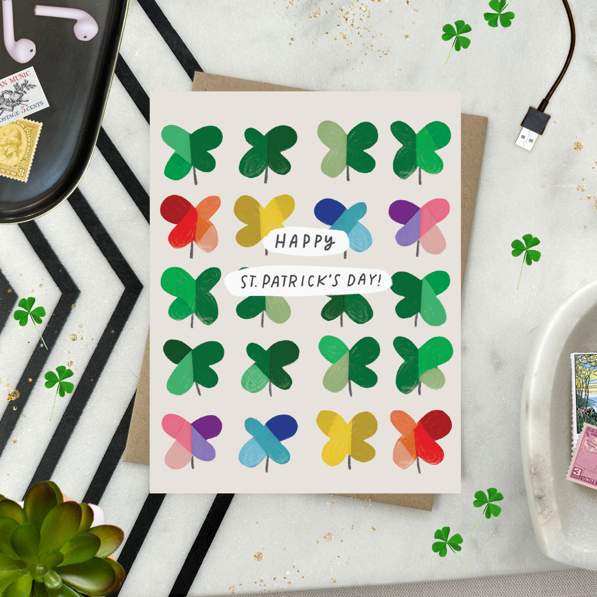 A St. Patrick's Day greeting card featuring a grid of colorful, painterly shamrocks with the message 'Happy St. patricks day