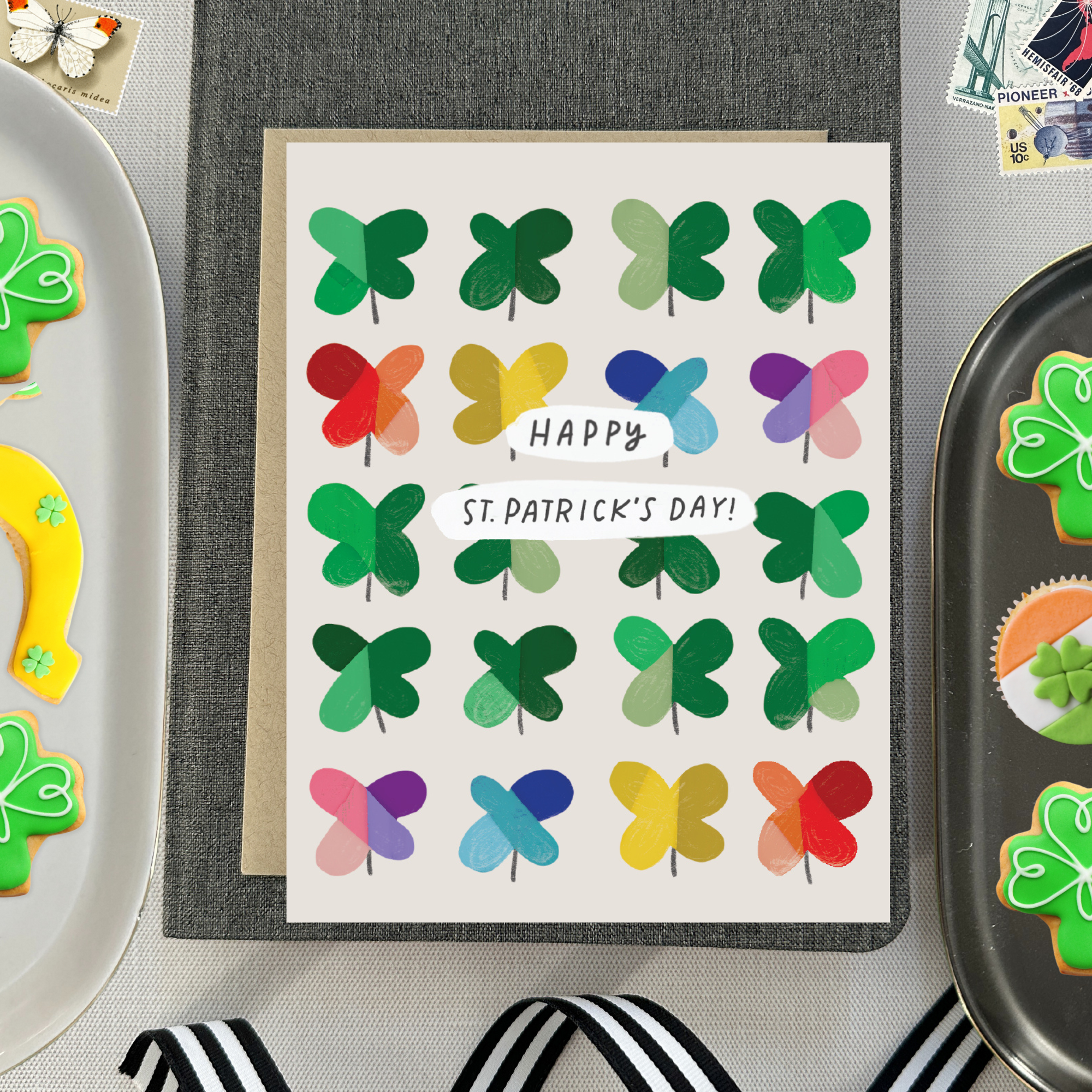 A St. Patrick's Day greeting card featuring a grid of colorful, painterly shamrocks with the message 'Happy St. patricks day