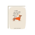 Birthday card with a dachshund in a party hat and the words 'I hope you see a dog today and it makes you smile. Happy Birthday.'