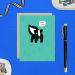 A sorry greeting card with an illustration of a skunk and the text 'Sorry I Stink' on a teal background.