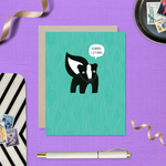 A sorry greeting card with an illustration of a skunk and the text 'Sorry I Stink' on a teal background.