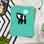 A sorry greeting card with an illustration of a skunk and the text 'Sorry I Stink' on a teal background.