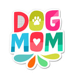 A colorful die-cut vinyl sticker with the text 'DOG MOM' and a paw print symbol.